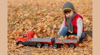 Child playing with truck and trailer